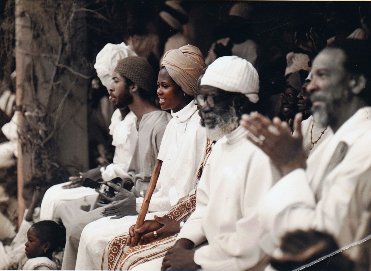Elders of the Village of Peace seated together in white garments during a spiritual gathering